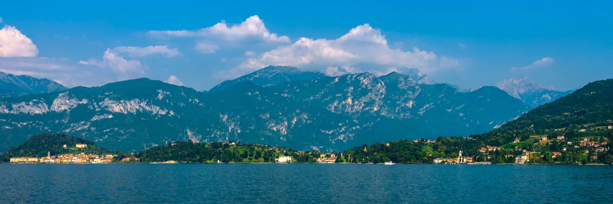 A vintage Riva Aquarama gliding across the glassy surface of Lake Como