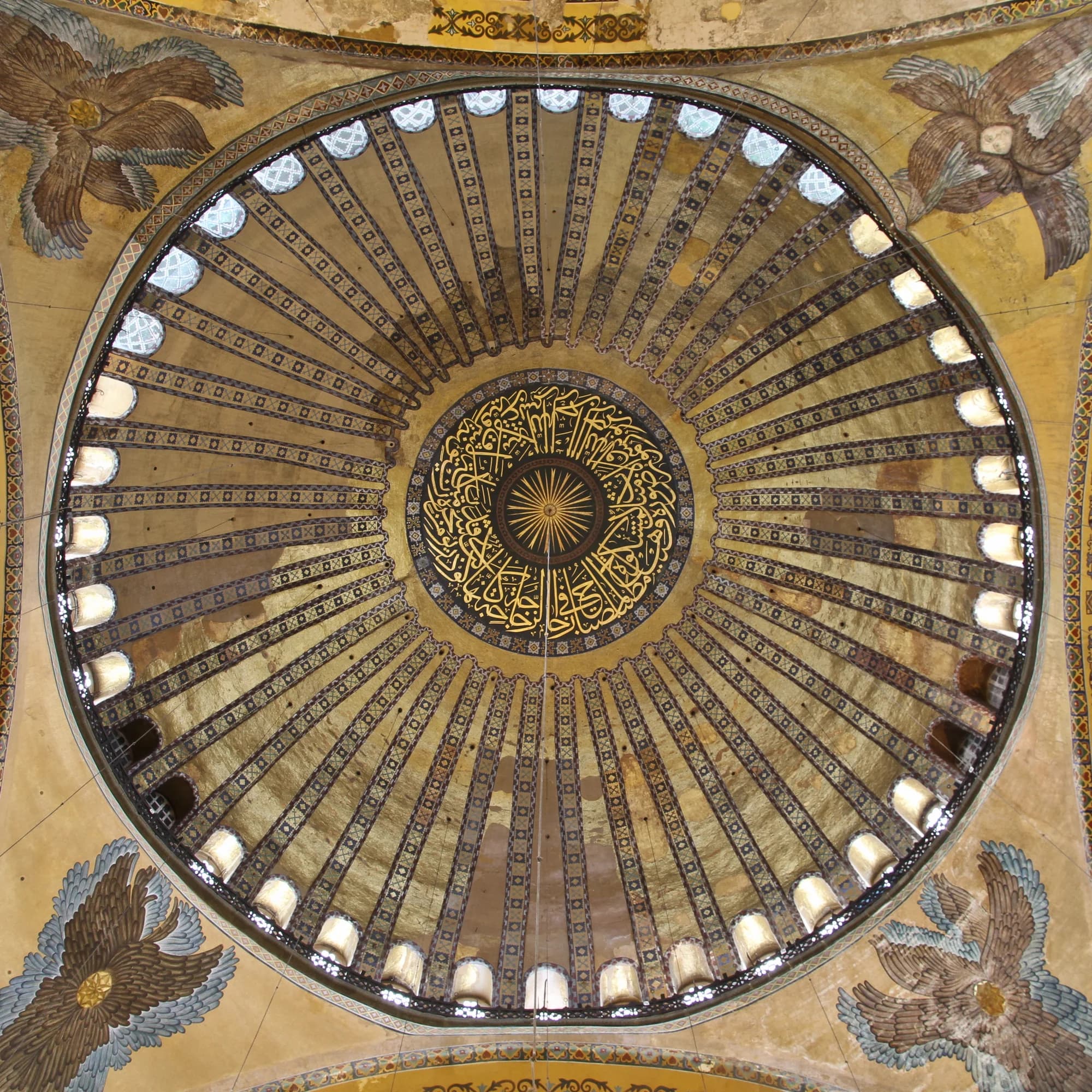 The interior of Hagia Sophia — the great dome floating on its ring of forty windows, shafts of morning light cutting through the incense-laden air, the golden mosaics of the apse glowing against the cool grey of the marble walls