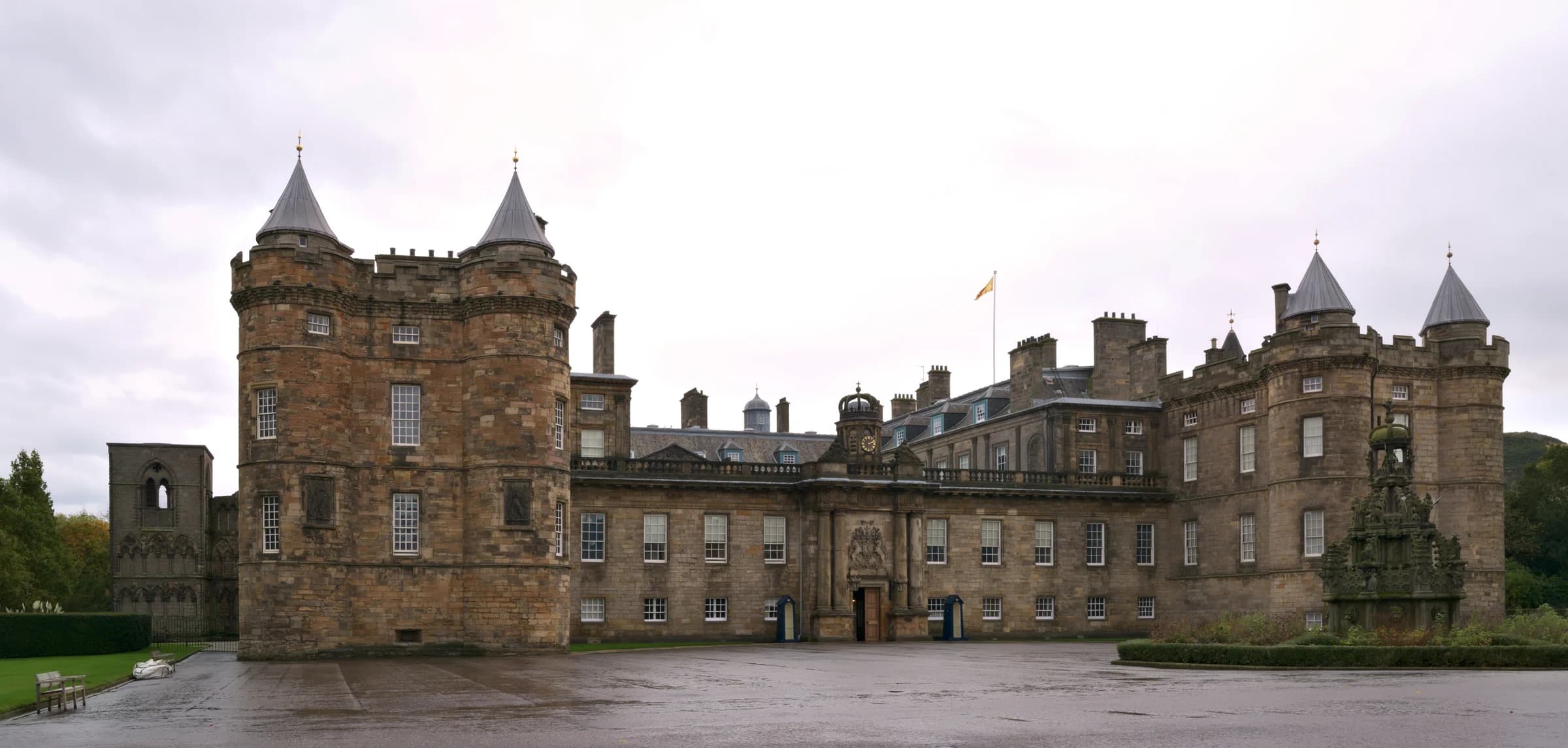 The Palace of Holyroodhouse grand facade and historic courtyard fountain in Edinburgh