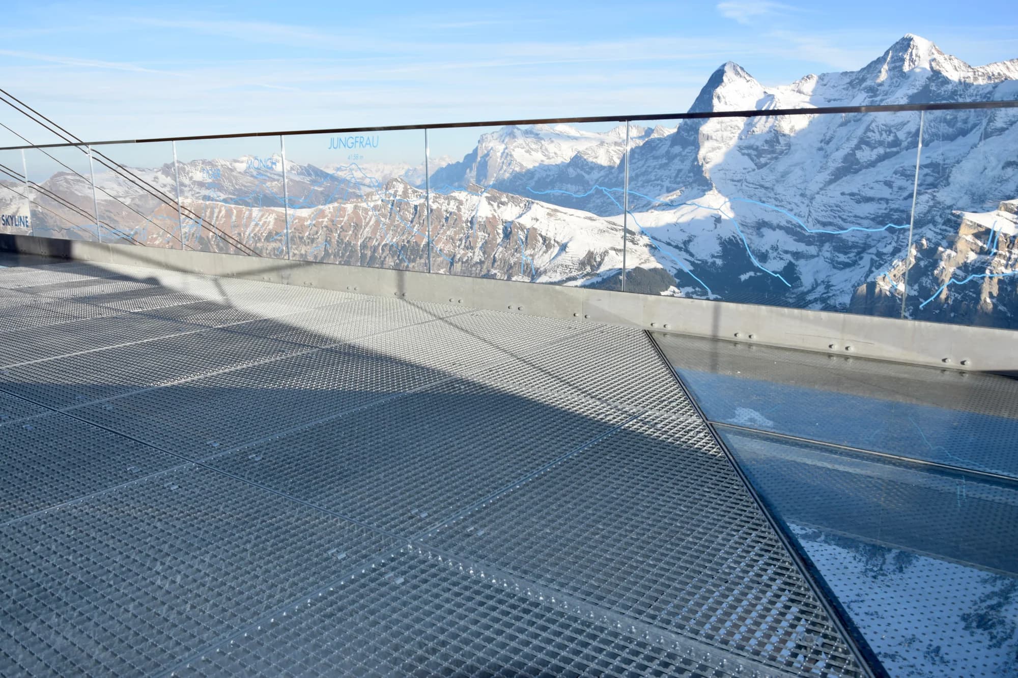 The Sphinx Terrace at Jungfraujoch — the viewing platform suspended 3,571 metres above sea level, the Aletsch Glacier a river of ice flowing toward the horizon, the air so clear it seems to magnify the distance, the temperature a reminder that you are standing on the roof of Europe